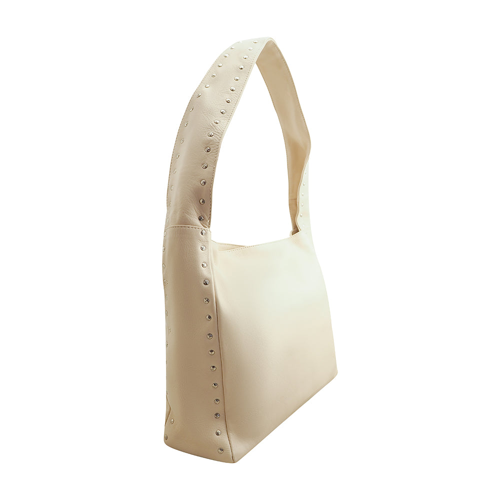 Cadelle Blondie cream leather hobo bag with stud detailing and slouchy shape side view