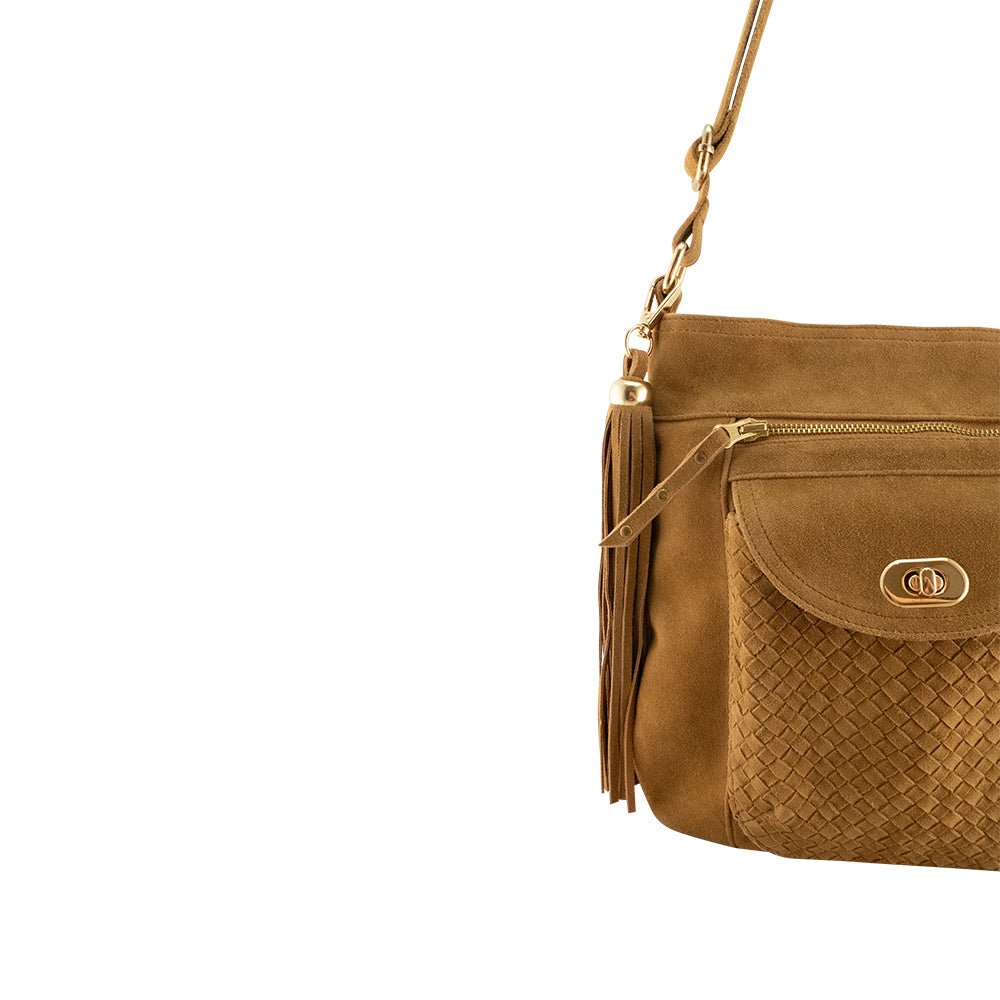 Cadelle Shelley tan suede crossbody bag with woven flap and gold key lock close up view