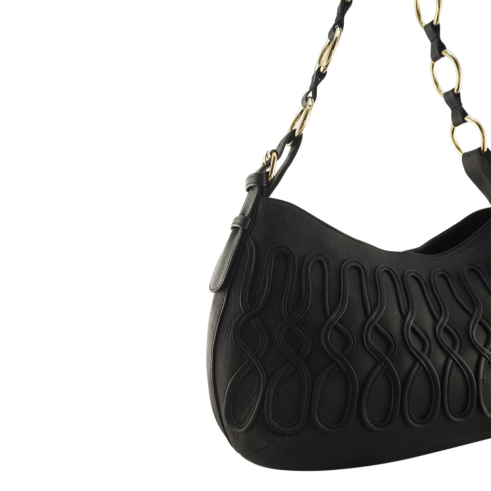 Cadelle Susie black leather handbag with slouchy shape and zip pockets close up view
