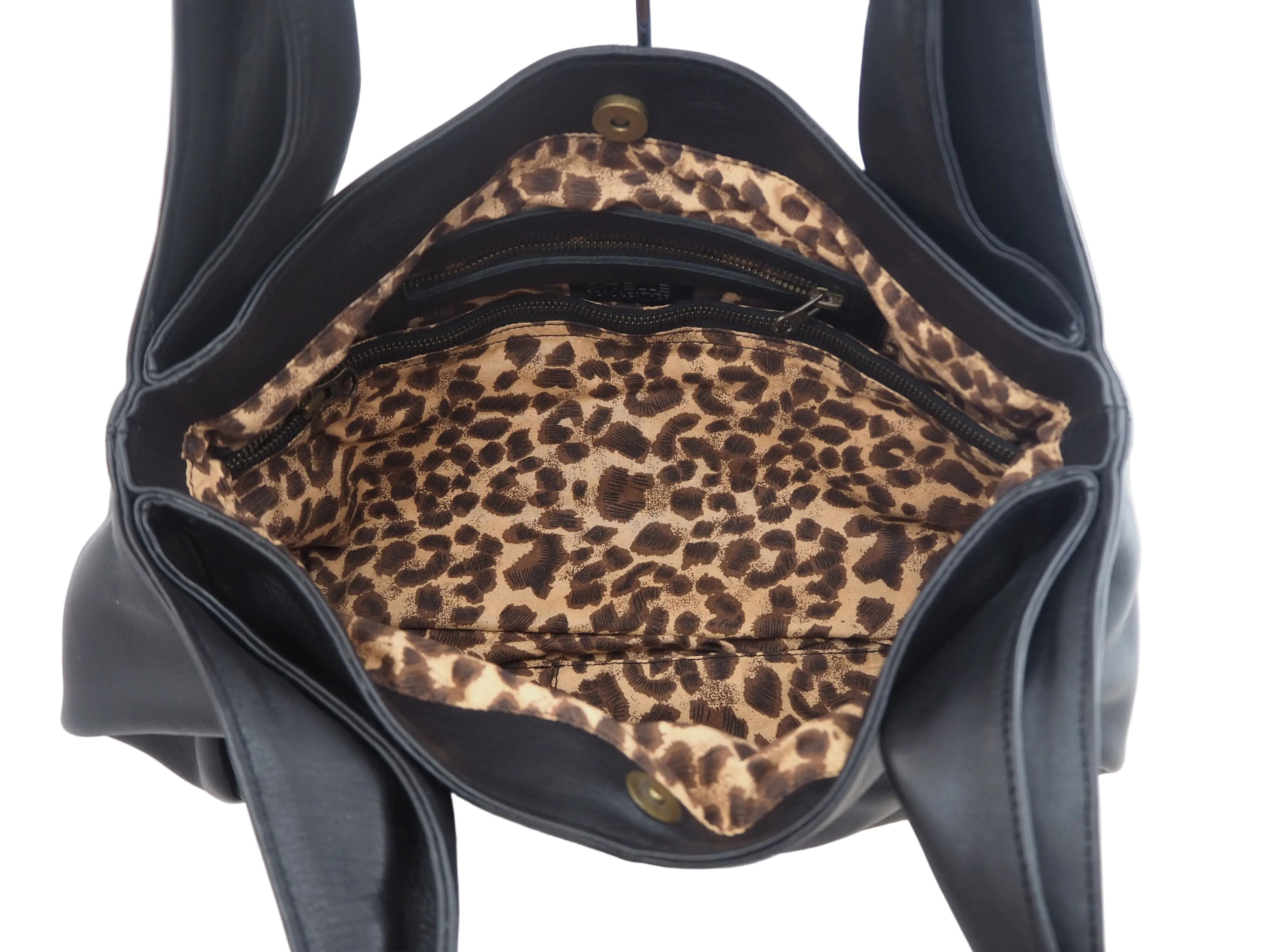 Black leather handbag with leopard print interior
