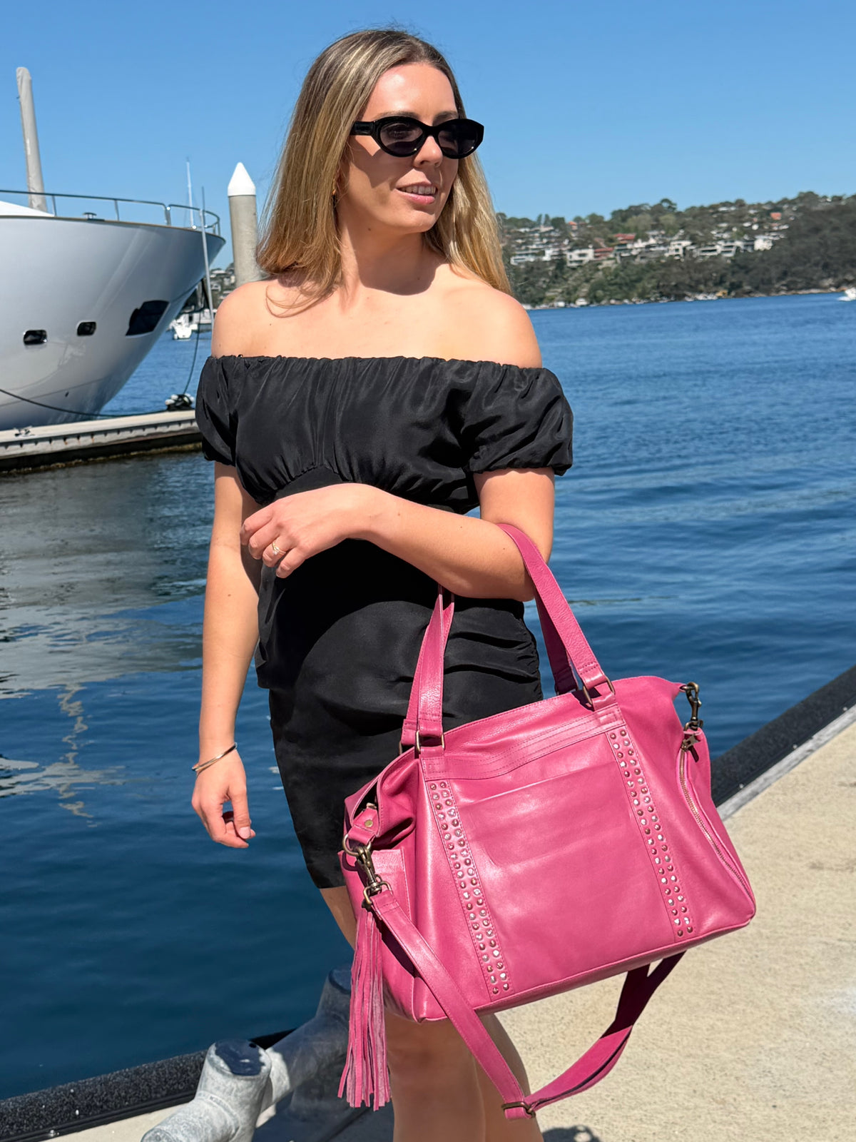 Cadelle Victoria raspberry leather overnighter with studs down the front and dual handles