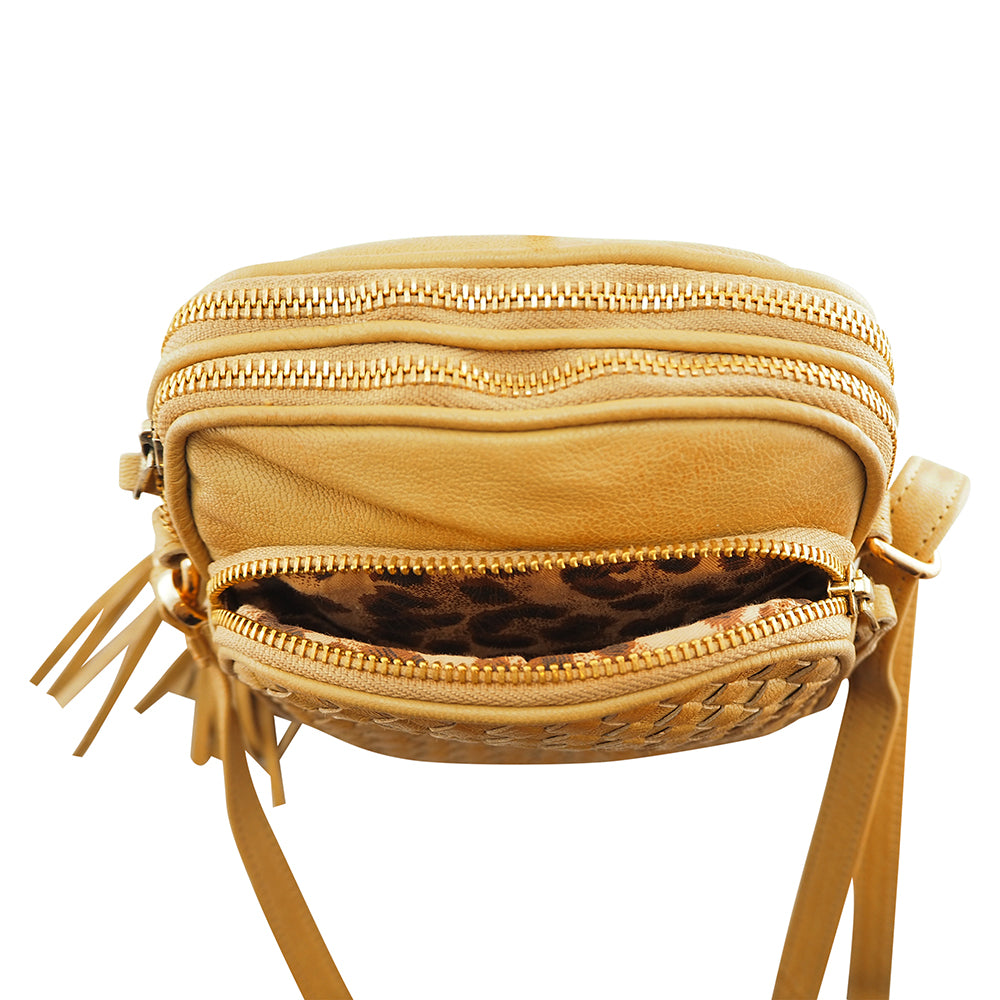 Cadelle Pippa camel leather crossbody bag with woven front zip pocket top view