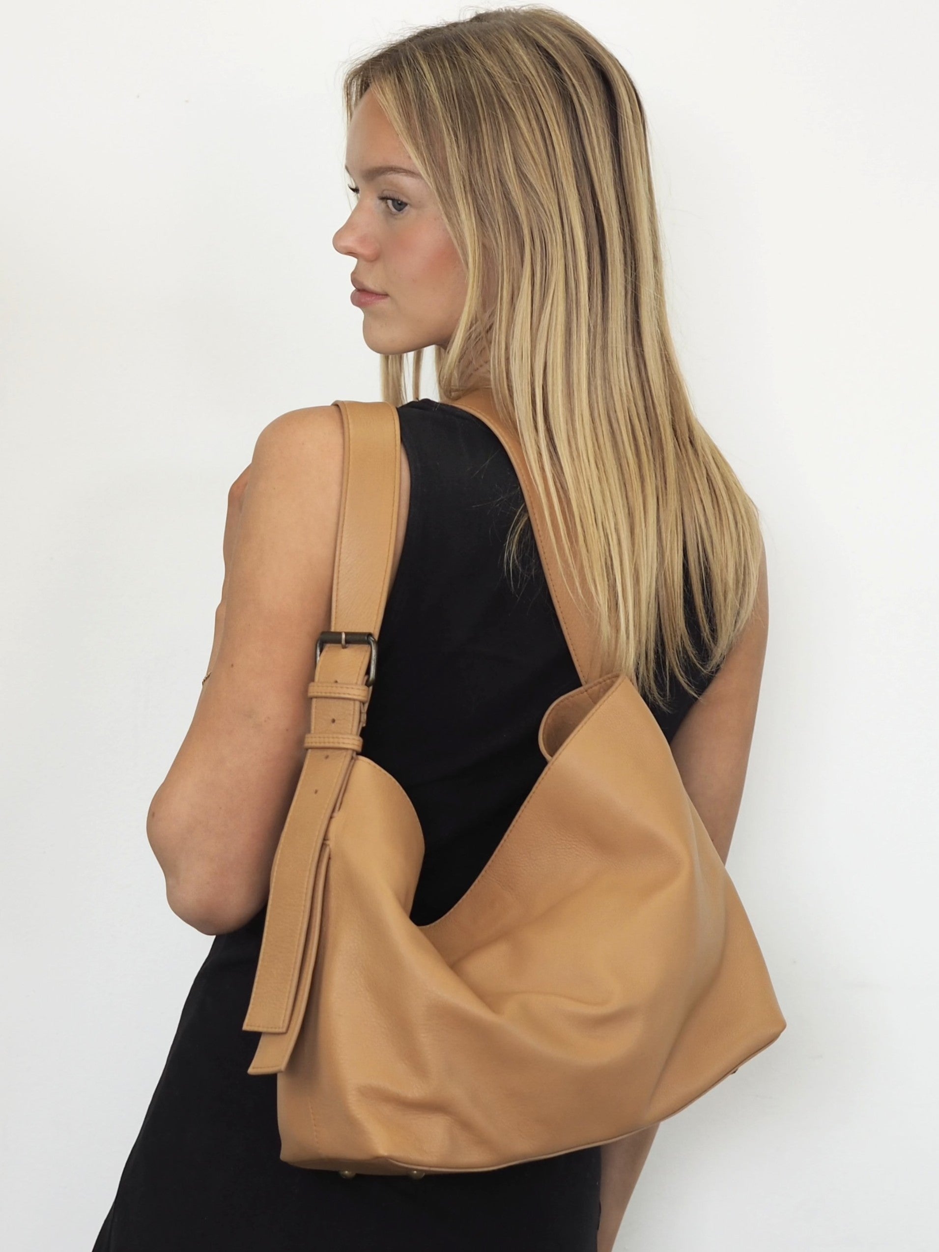 Tan leather shoulder bag with adjustable buckle on strap
