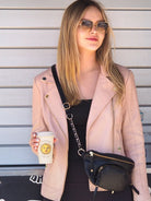 Cadelle Tully black leather sling bag with front zip pocket and adjustable strap