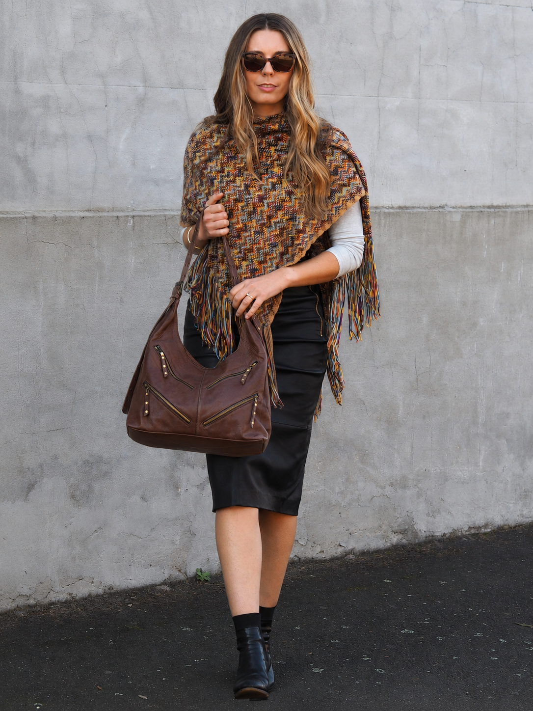 Bailey hobo in chocolate leather with front zip pockets- lifestyle shot