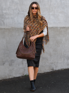 Bailey hobo in chocolate leather with front zip pockets- lifestyle shot