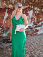 Cadelle Gigi cream leather crossbody worn as a clutch