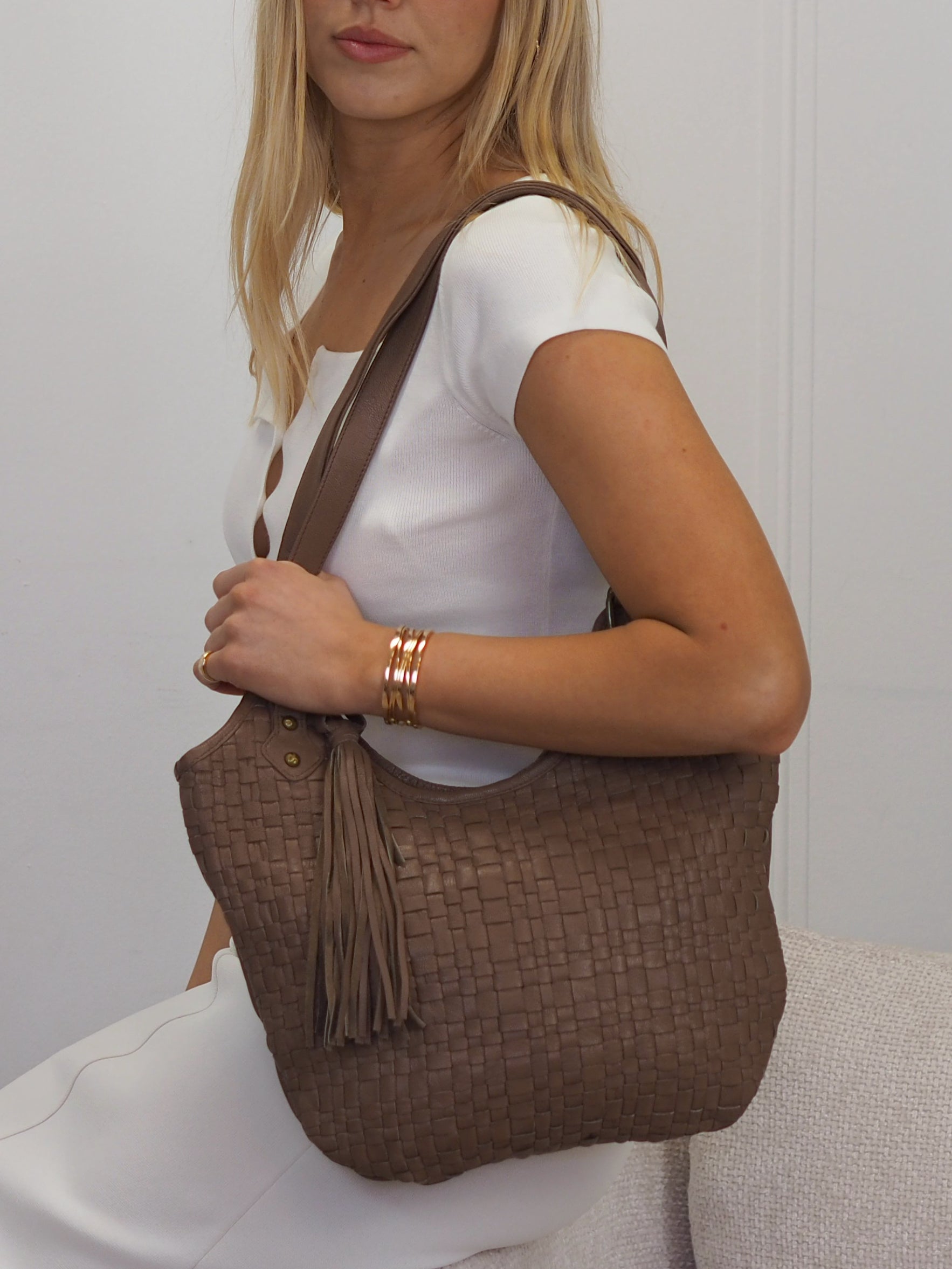  Truffle brown woven leather front shoulder bag with detachable  tassel detail. 