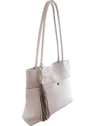 Cadelle Billie white leather tote bag with a woven upper panel, dual shoulder straps, and a detachable tassel 