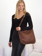 Elli chocolate leather convertible backpack worn as a shoulder bag
