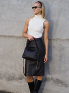 Cadelle Lyndel black leather handbag with diamond quilted stitching and gold chain strap