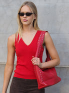 Cadelle Blondie red leather hobo bag with stud detailing and slouchy shape