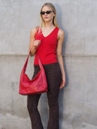 Cadelle Blondie red leather hobo bag with stud detailing and slouchy shape