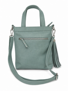 Back view of Carter leather handbag with dual top handles, a zippered pocket, a detachable shoulder strap, and a tassel detail