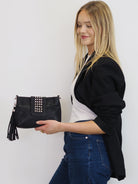 Gigi black leather crossbody with silver stud detail and detachable tassel