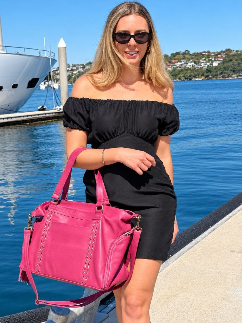 Cadelle Victoria raspberry leather overnighter with studs down the front