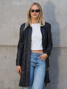 Navy leather trench coat worn open