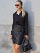 Black leather skirt with zip front and zip pockets
