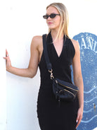 Cadelle Dotti black leather sling bag with adjustable wide strap and multiple zip pockets