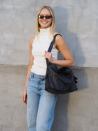 Cadelle Piper black leather shoulder bag with structured design side view