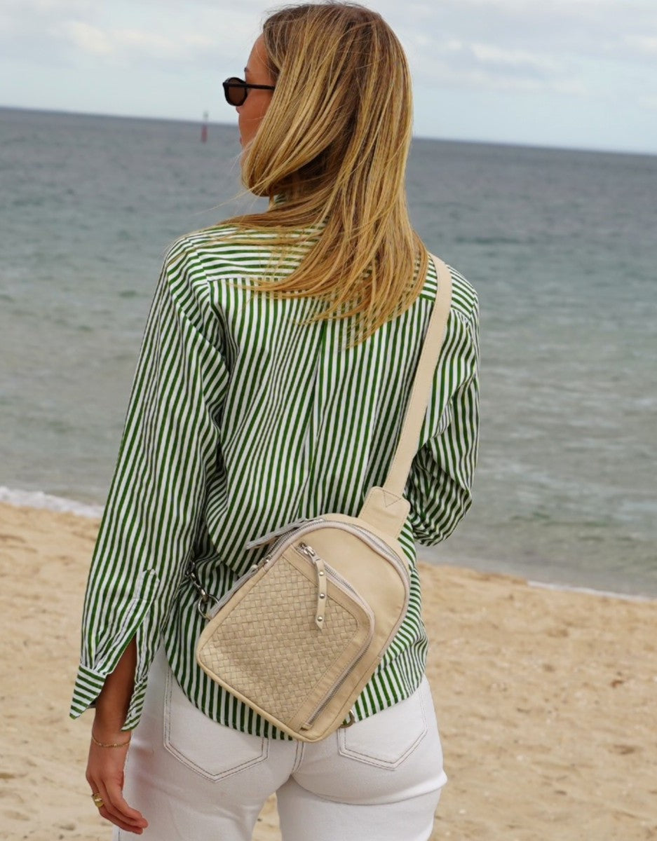 Cadelle Karissa cream leather sling bag with woven front pocket