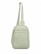 Cadelle Karissa mint green leather crossbody bag with a woven texture on the front pocket and a single shoulder strap and multiple pockets