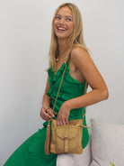 Jamie camel leather woven front pocket  crossbody bag with gold hardware and a detachable tassel 
