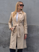 Cadelle Claire beige leather trench coat with button front front view