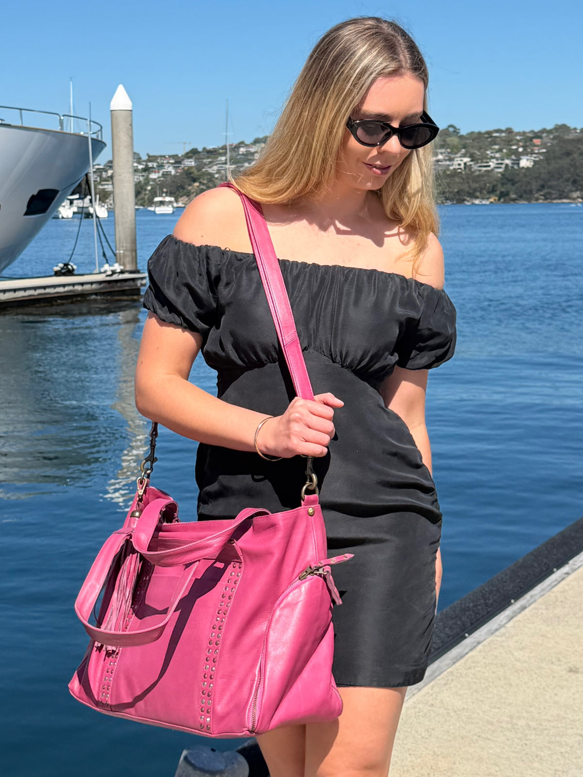 Cadelle Victoria raspberry leather overnighter with studs down the front and dual handles
