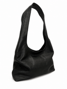 Scarlett  black slouchy leather shoulder bag with a single strap, side view